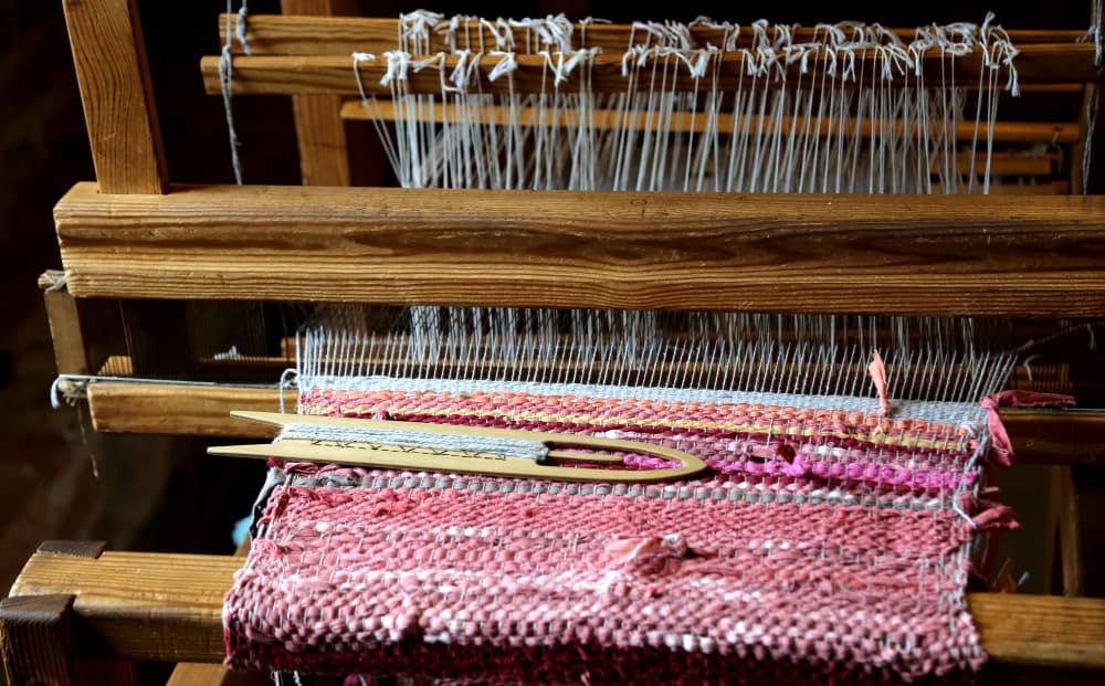 Traditional carpet weaving loom with artisan at work